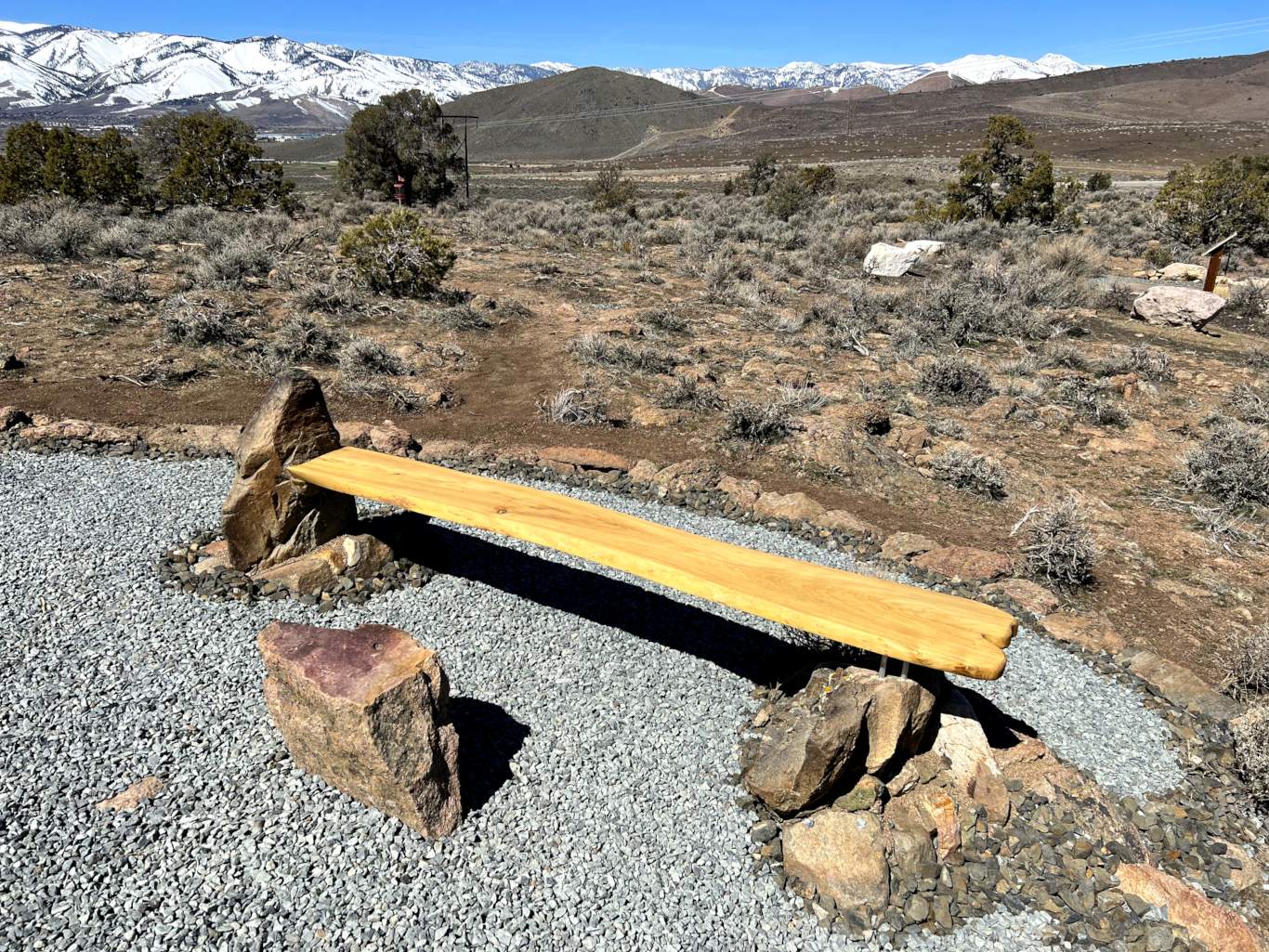 close-up of live-edge bench anchored into native rock